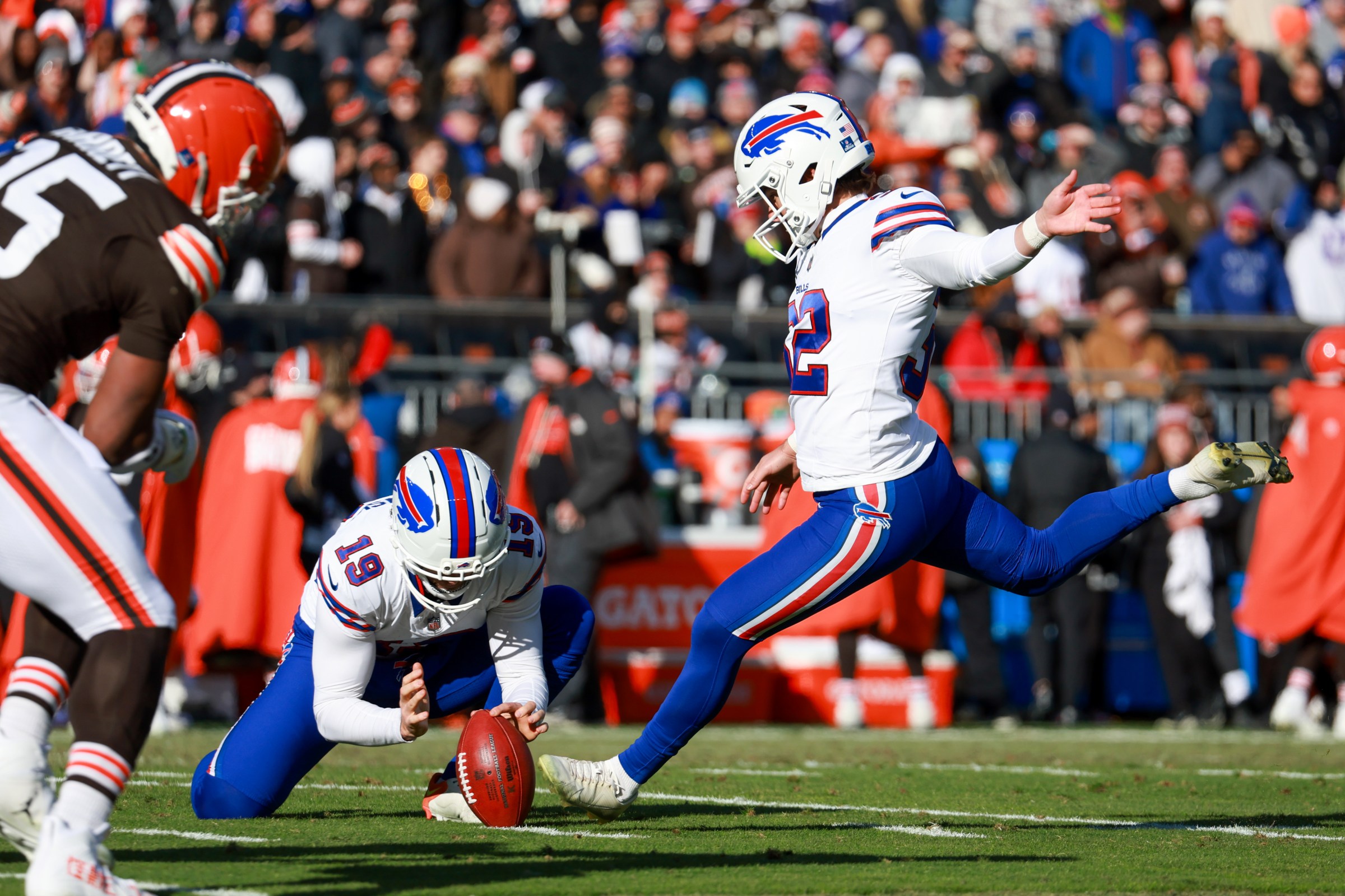 CLEVELAND, OH - DECEMBER 21: Buffalo Bills place kicker Michael Badgley (32) kicks an extra point out of the hold of Buffalo Bills punter Mitch Wishnowsky (19) during the second quarter of the National Football League game between the Buffalo Bills and Cleveland Browns on December 21, 2025, at Huntington Bank Field in Cleveland, OH. (Photo by Frank Jansky/Icon Sportswire via Getty Images)