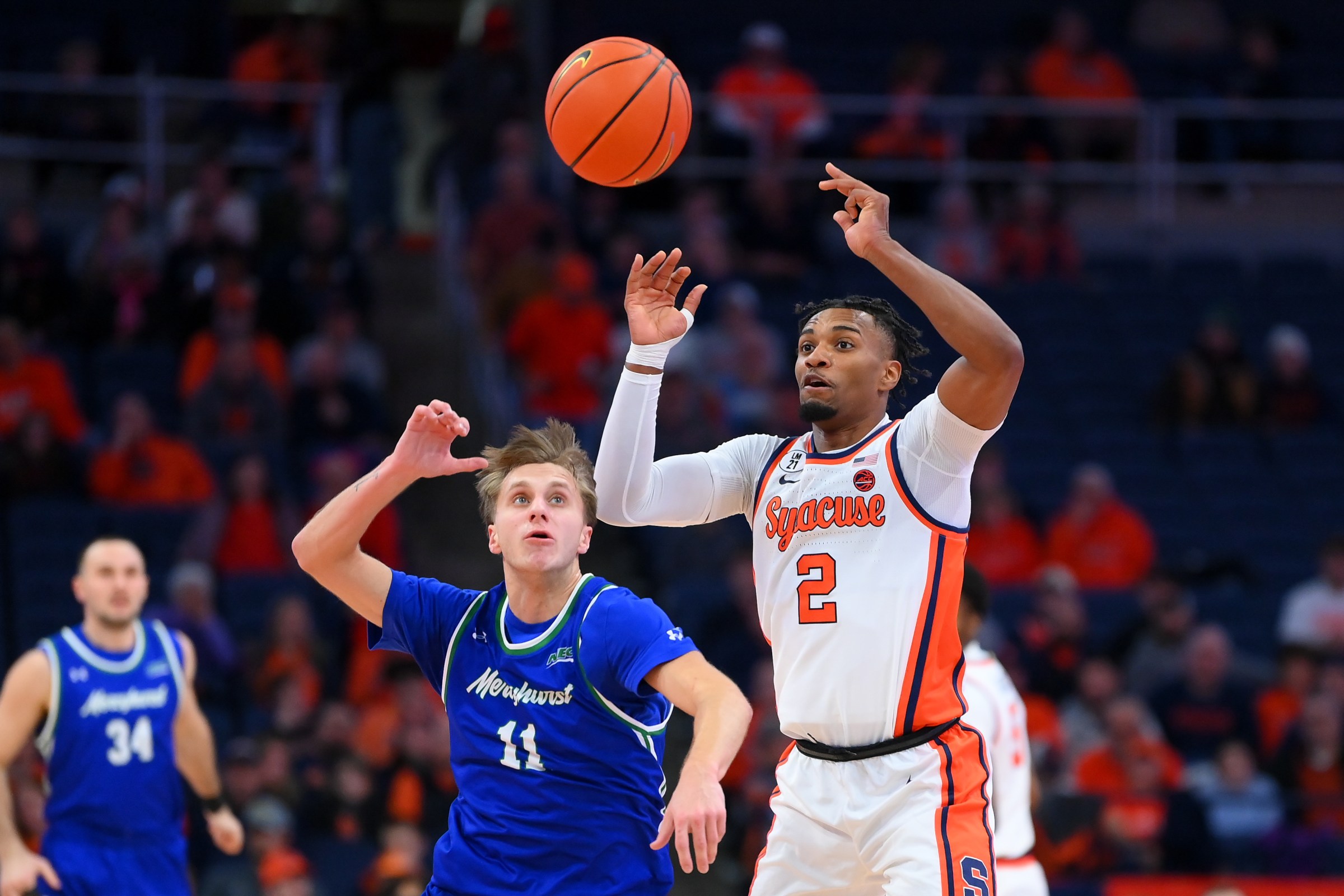 Dec 17, 2025; Syracuse, New York, USA; Mercyhurst Lakers guard Jake Lemelman (11) and Syracuse Orange guard J.J. Starling (2) react to a loose ball during the first half at the JMA Wireless Dome. Mandatory Credit: Rich Barnes-Imagn Images