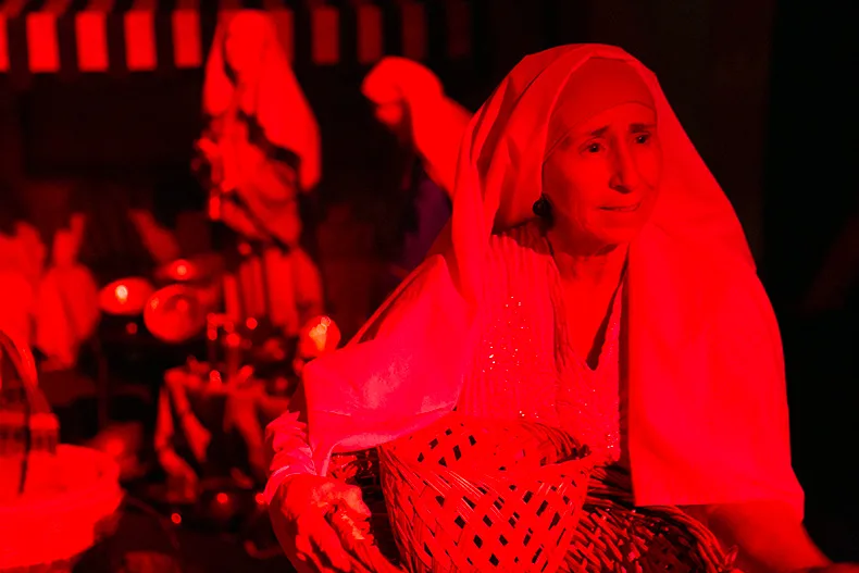 The travelers seek information about the star and the new king at a marketplace. Above, a merchant. 