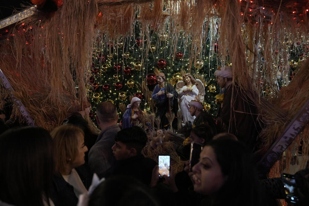 Crowds take part in a Christmas tree–lighting event in Manger Square, next to the Church of the Nativity, traditionally regarded as the birthplace of Jesus Christ ahead of Christmas in the West Bank city of Bethlehem Saturday, Dec. 6, 2025 