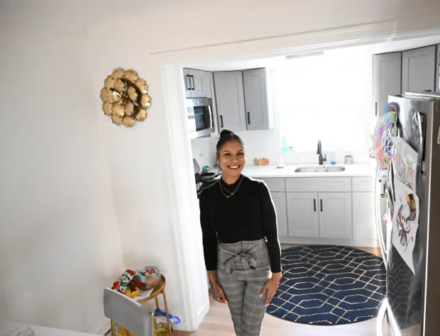 Tianna Williams stands in her home Friday, Dec. 12, 2025, in North Catasauqua. Williams, 30, is suing M&T Bank for discrimination, claiming the bank's wrongful actions cost her her successful car-sales business. (Amy Shortell / The Morning Call)