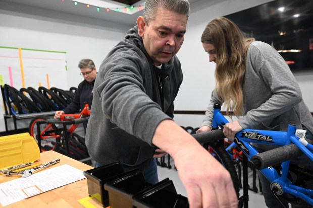 Richard Stanley volunteers to build a bike during the Manufacturers Resource Center's annual Santa's Standard Workshop on Wednesday, Dec. 10, 2025, in Upper Macungie Township. Workers from Just Born, Lutron, Northeast Products & Services and Ocean Spray came together to assemble bikes for Community Bike Works youth while learning lean manufacturing principles. (Amy Shortell / The Morning Call)