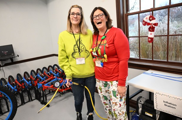 Rachel Vega and Cheryl Galan volunteer to build a bike during the Manufacturers Resource Center's annual Santa's Standard Workshop on Wednesday, Dec. 10, 2025, in Upper Macungie Township. Workers from Just Born, Lutron, Northeast Products & Services and Ocean Spray came together to assemble bikes for Community Bike Works youth while learning lean manufacturing principles. (Amy Shortell / The Morning Call)