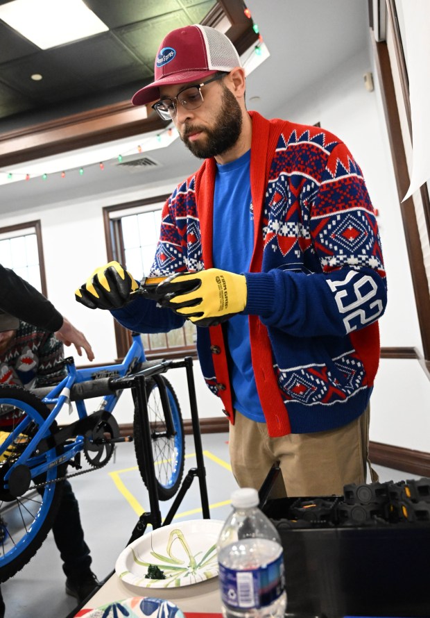 John Maldonado volunteers to build a bike during the Manufacturers Resource Center's annual Santa's Standard Workshop on Wednesday, Dec. 10, 2025, in Upper Macungie Township. Workers from Just Born, Lutron, Northeast Products & Services and Ocean Spray came together to assemble bikes for Community Bike Works youth while learning lean manufacturing principles. (Amy Shortell / The Morning Call)