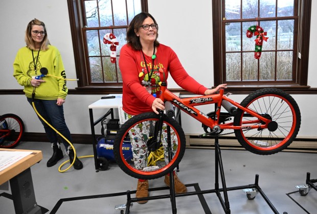 Cheryl Galan volunteers to build a bike during the Manufacturers Resource Center's annual Santa's Standard Workshop on Wednesday, Dec. 10, 2025, in Upper Macungie Township. Workers from Just Born, Lutron, Northeast Products & Services and Ocean Spray came together to assemble bikes for Community Bike Works youth while learning lean manufacturing principles. (Amy Shortell / The Morning Call)