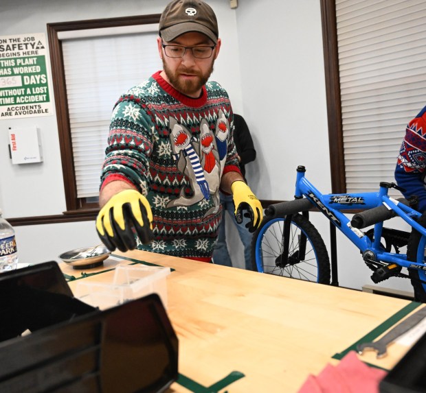 Brandan Sangrey volunteers to build a bike during the Manufacturers Resource Center's annual Santa's Standard Workshop on Wednesday, Dec. 10, 2025, in Upper Macungie Township. Workers from Just Born, Lutron, Northeast Products & Services and Ocean Spray came together to assemble bikes for Community Bike Works youth while learning lean manufacturing principles. (Amy Shortell / The Morning Call)