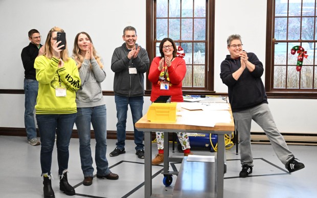 People cheer as the last bicycle is completed during the Manufacturers Resource Center's annual Santa's Standard Workshop on Wednesday, Dec. 10, 2025, in Upper Macungie Township. Workers from Just Born, Lutron, Northeast Products & Services and Ocean Spray came together to assemble bicycles for Community Bike Works youth while learning lean manufacturing principles. (Amy Shortell/The Morning Call)