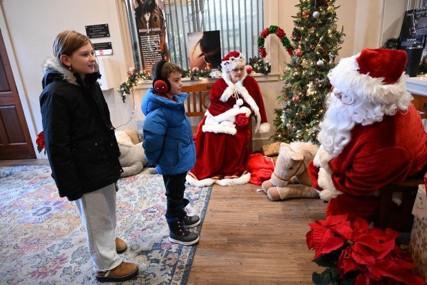 Angelina McCauley,10, and her brother Jameson,7,both of Bethlehem, greet Santa and Mrs. Claus during the Holiday with the Horses open house Sunday, Dec. 7, 2025, at the Bethlehem mounted police unit's barn. (Amy Shortell/The Morning Call)