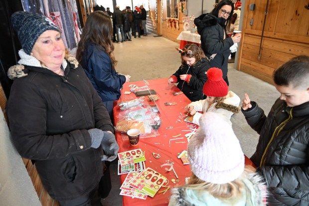 Children enjoy a craft table during the Holiday with the Horses open house Sunday, Dec. 7, 2025, at the Bethlehem mounted police unit's barn. (Amy Shortell/The Morning Call)