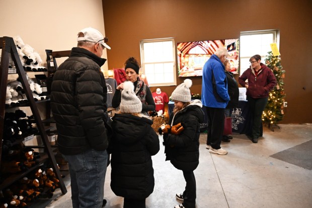 People shop at the Bethlehem mounted police unit's gift shop during the Holiday with the Horses open house Sunday, Dec. 7, 2025, at the unit's barn. (Amy Shortell/The Morning Call)