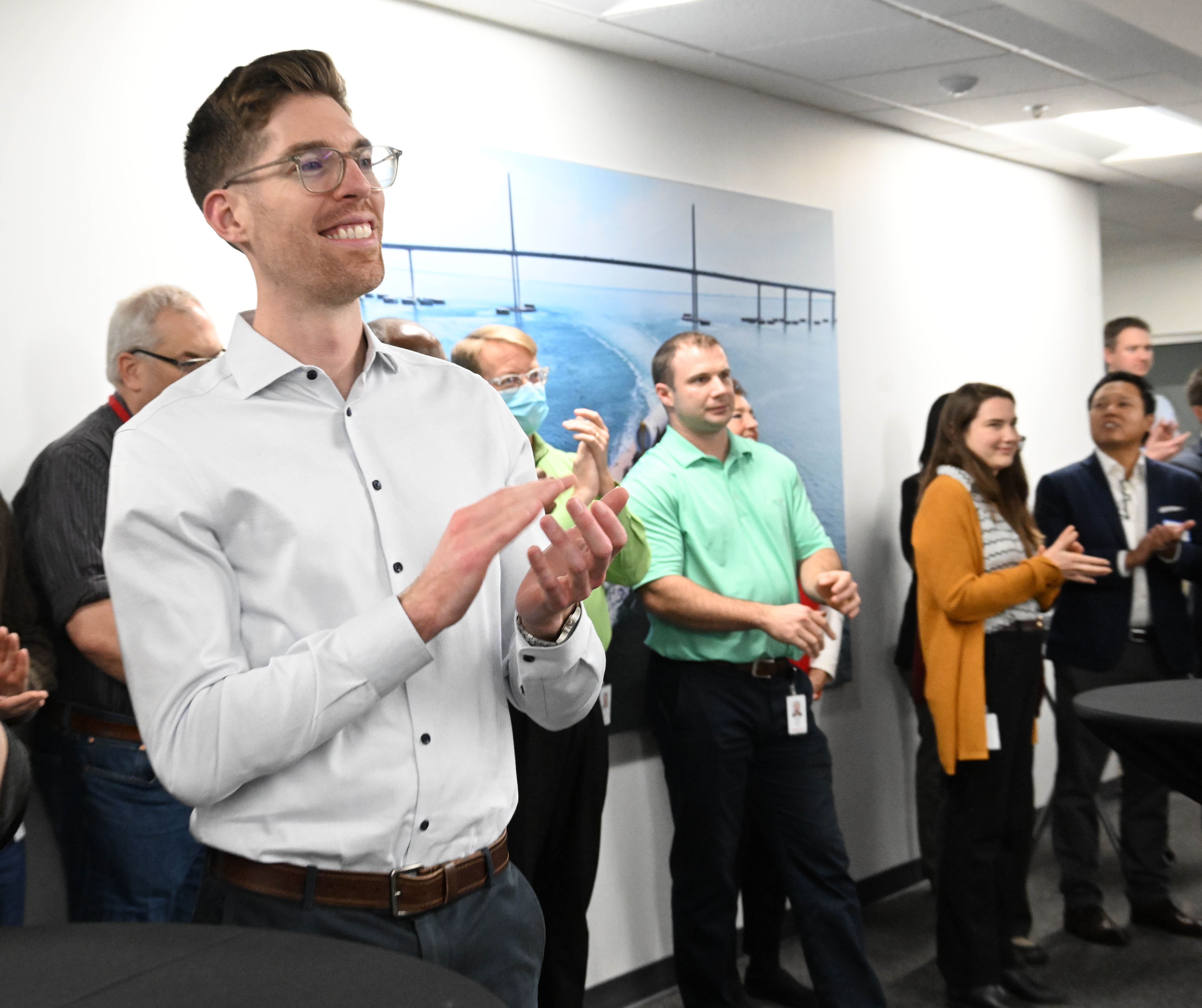 Honeywell employees applaud during a ribbon-cutting ceremony Friday, Dec. 19,...
