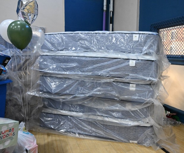 Toys and mattresses are seen prior to being handed out Monday, Dec. 22, 2025, at the Salvation Army in Allentown. The foundation, Salvation Army and Ashley's Furniture joined to donate beds, mattresses and toys to Lehigh Valley families in need, including some whose homes were burned in recent fires. (Amy Shortell/The Morning Call)