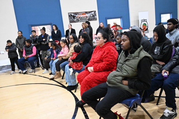 Families listen to speakers Monday, Dec. 22, 2025, at the Salvation Army in Allentown. The Michael Ann and Saquon Barkley Hope Foundation, Salvation Army and Ashley's Furniture joined to donate beds, mattresses and toys to Lehigh Valley families in need, including some whose homes were burned in recent fires. (Amy Shortell/The Morning Call)