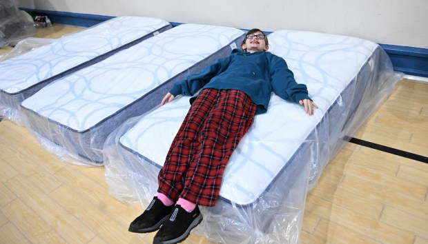 Grace Brown tries out a new mattress Monday, Dec. 22, 2025, at the Salvation Army in Allentown. The Michael Ann and Saquon Barkley Hope Foundation, Salvation Army and Ashley's Furniture joined to donate beds, mattresses and toys to Lehigh Valley families in need, including some whose homes were burned in recent fires. (Amy Shortell/The Morning Call)