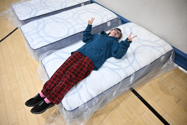Grace Brown tries out a new mattress Monday, Dec. 22, 2025, at the Salvation Army in Allentown. The Michael Ann and Saquon Barkley Hope Foundation, Salvation Army and Ashley's Furniture joined to donate beds, mattresses and toys to Lehigh Valley families in need, including some whose homes were burned in recent fires. (Amy Shortell/The Morning Call)
