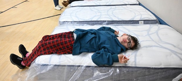 Grace Brown tries out a new mattress Monday, Dec. 22, 2025, at the Salvation Army in Allentown. The Michael Ann and Saquon Barkley Hope Foundation, Salvation Army and Ashley's Furniture joined to donate beds, mattresses and toys to Lehigh Valley families in need, including some whose homes were burned in recent fires. (Amy Shortell/The Morning Call)