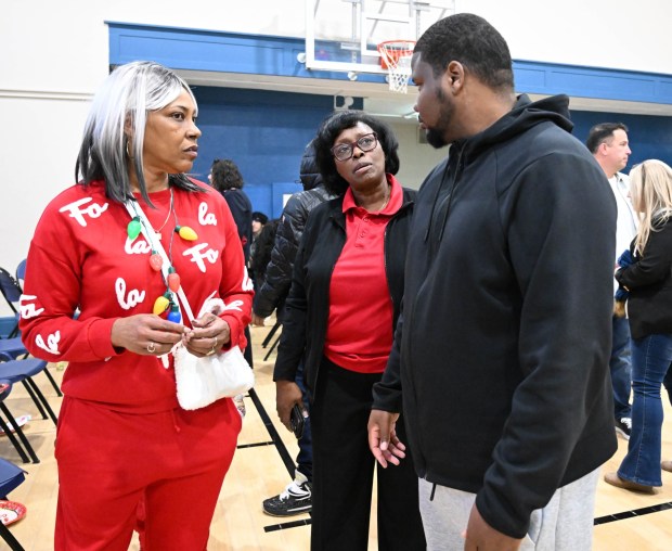 Jamil Thomas of Allentown talks with Tonya Johnson, All-Pro running back Saquon Barkley's mom and vice president of the Michael Ann and Saquon Barkley Hope Foundation,  during Monday, Dec. 22, 2025, at the Salvation Army in Allentown. The foundation, Salvation Army and Ashley's Furniture joined to donate beds, mattresses and toys to Lehigh Valley families in need, including some whose homes were burned in recent fires. (Amy Shortell/The Morning Call)