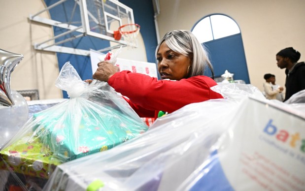 Tonya Johnson, All-Pro running back Saquon Barkley's mom and vice president of the Michael Ann and Saquon Barkley Hope Foundation, hands out toys to children Monday, Dec. 22, 2025, at the Salvation Army in Allentown. The foundation, Salvation Army and Ashley's Furniture joined to donate beds, mattresses and toys to Lehigh Valley families in need, including some whose homes were burned in recent fires. (Amy Shortell/The Morning Call)