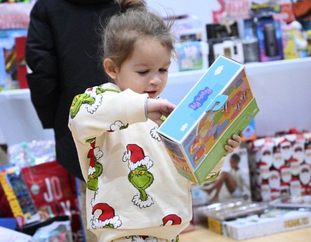 Archie Merced, 3, of Allentown shows off a Pepa Pig toy he selected Monday, Dec. 22, 2025, at the Salvation Army in Allentown. The Michael Ann and Saquon Barkley Hope Foundation, Salvation Army and Ashley's Furniture joined to donate beds, mattresses and toys to Lehigh Valley families in need, including some whose homes were burned in recent fires. (Amy Shortell/The Morning Call)