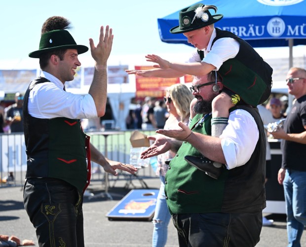 Chris Siegmann dances with Max Clark, 8, riding on his shoulders Sunday, Oct. 5, 2025, at the 15th annual Oktoberfest at SteelStacks in Bethlehem. The festival continues Oct. 10-12. (Amy Shortell/The Morning Call)
