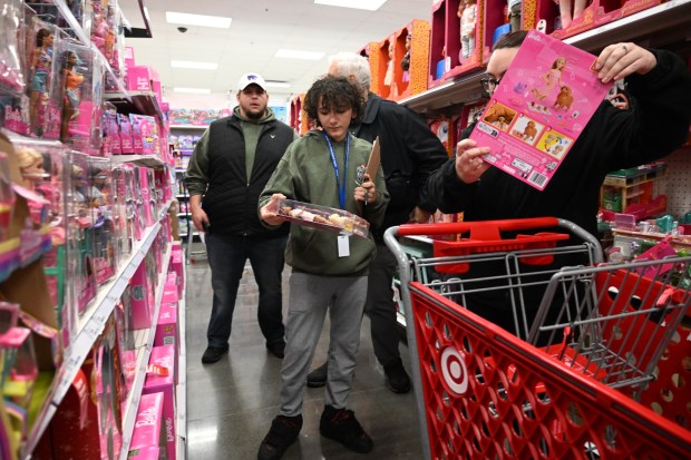 Matthias Slenbaker shops with Saturday, Dec. 6, 2025,  at Target in Allentown during Shop with an Airport Cop.(Amy Shortell/The Morning Call)