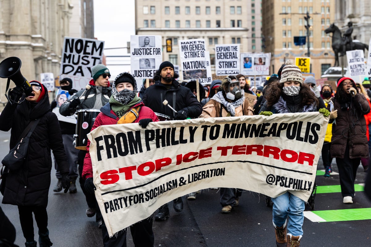Protesters outside City Hall hold a banner reading FROM PHILLY TO MINNEAPOLIS STOP ICE TERROR
