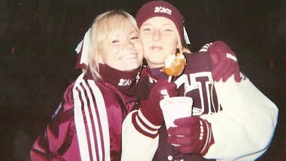 A young Caitlin O'Connor with a friend wearing burgundy sports jackets.