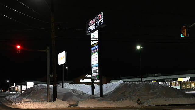 <p>You can barely see the Insalaco Shopping Center from Wyoming Avenue in West Pittston, with mounds of snow piled up to 10 feet.</p>
<p>Tony Callaio | For Sunday Dispatch</p>