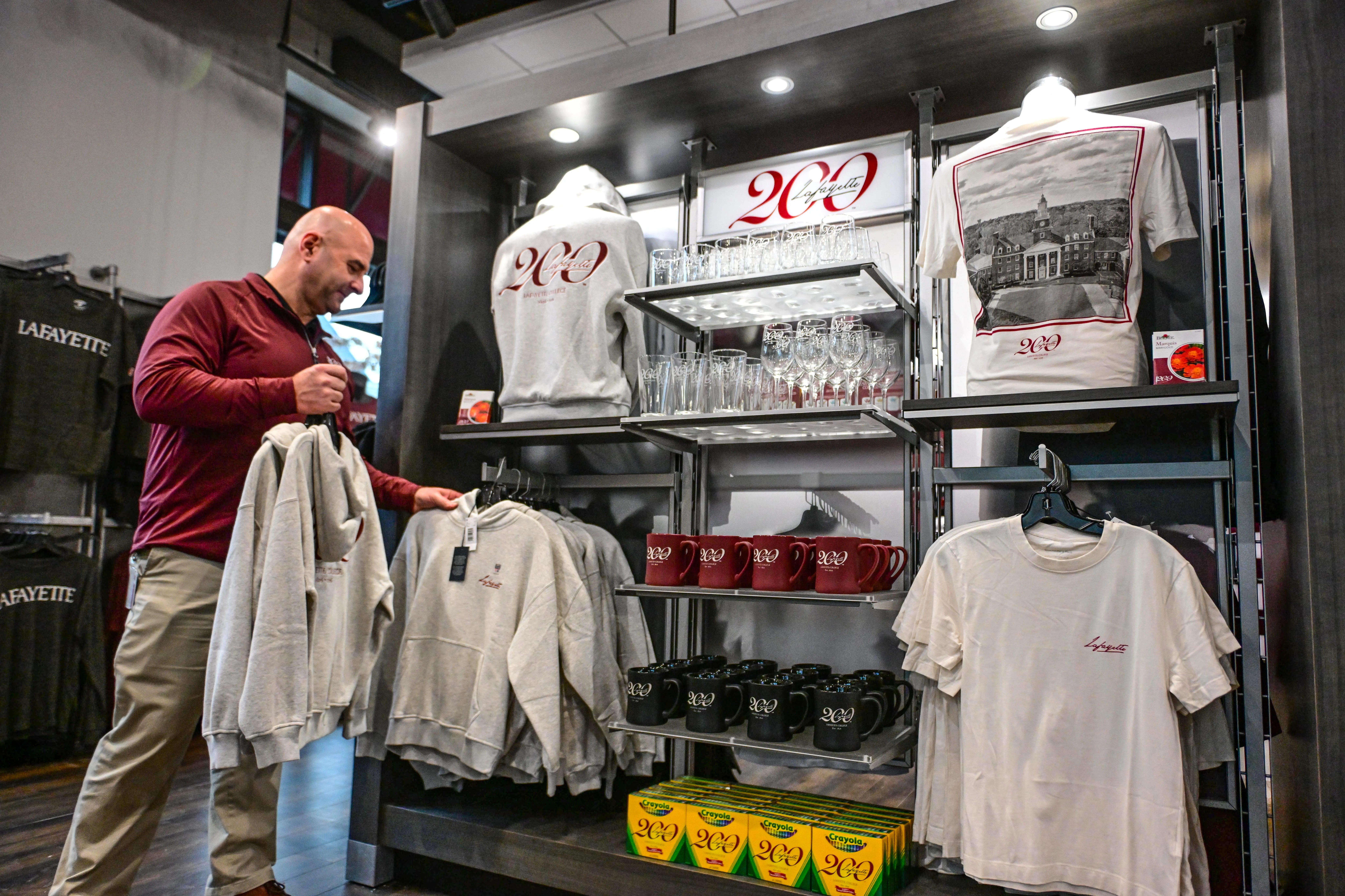 Lafayette College store manager Pete Violante arranges items Friday, Dec....