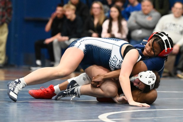 West Scranton's Kamiah Green, right, and Abington Heights' Grace Welch compete in the girls 124-pound bout Wednesday at West Scranton High School. Green won the match with a pin. (REBECCA PARTICKA/STAFF PHOTOGRAPHER)