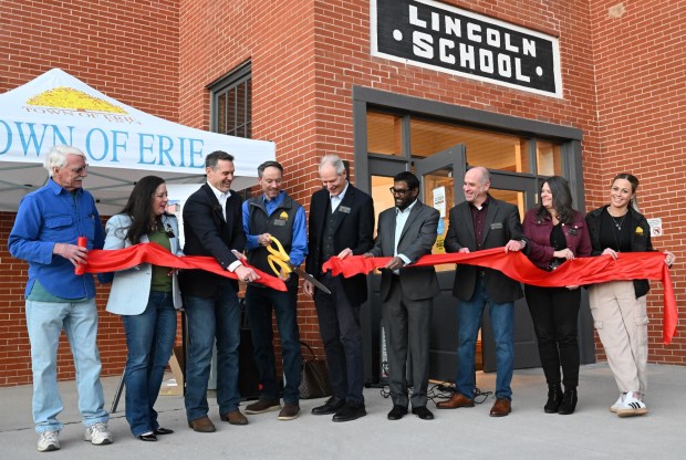 Erie officials and staff cut the ribbon to celebrate the renovated Town Hall building. (Cliff Grassmick/Daily Camera).