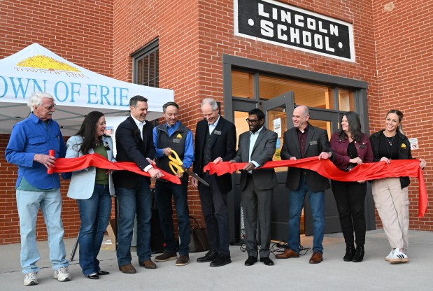 Erie officials and staff cut the ribbon to celebrate the renovated Town Hall building. (Cliff Grassmick/Daily Camera).