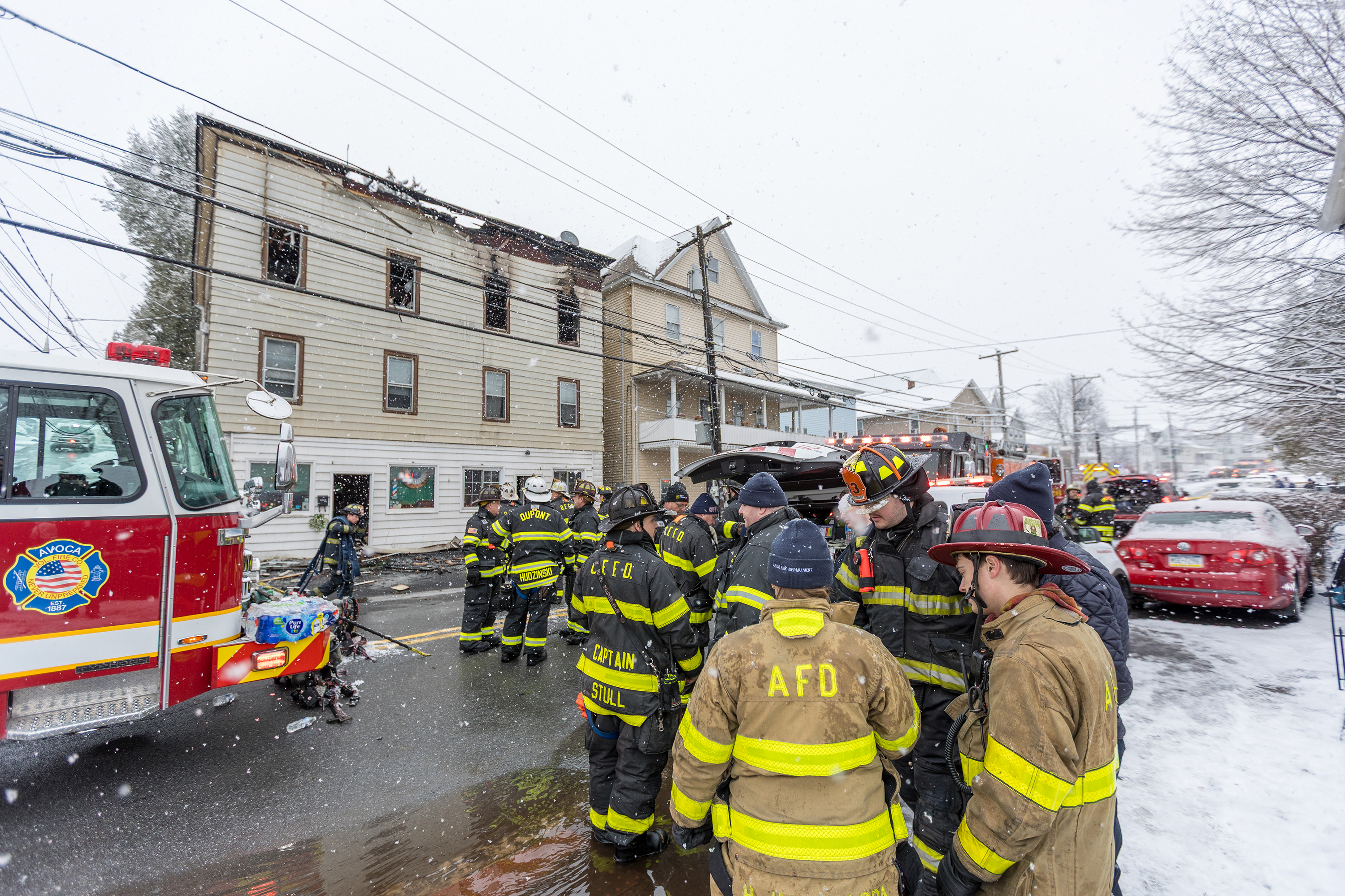 Firefighters work the scene at 628-630 McAlpine St. in Avoca...