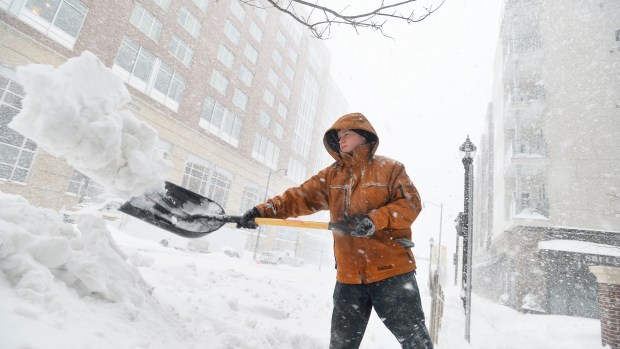 Maintenance worker Branden Hartman shovels snow near Allentown's Center Square on Saturday, Jan. 23, 2016, during the Blizzard of 2016. "I've been trying to keep up with the snow, but it doesn't seem to make a difference," he said. (April Bartolomew/The Morning Call)