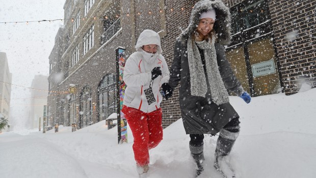 Stopping to take a selfie and then venturing out to go to the Dime resturant across the street, friends Sami Lerit of Allentown and Sky Matechic of Phillipsburg walk through a snow-covered Arts Walk in downtown Allentown on Saturday, Jan. 23, 2016, during the Blizzard of 2016. (April Bartholomew/The Morning Call)