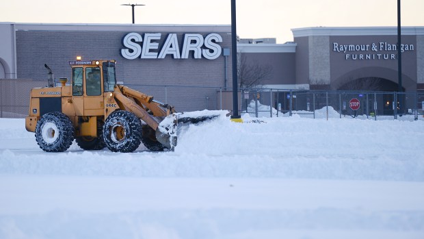 A front end loader piles snow in the parking lot shared by Sears and Kohl's at the Whitehall Mall in Whitehall Township late Sunday afternoon, Jan. 24, 2016. Lehigh Valley residents began the big cleanup after the Blizzard of 2016 dumped a record 31.9 inches of snow on the region. (Emily Paine/The Morning Call)