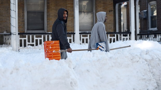 Two men walk down the sidewalk on Tilghman Street in Allentown on Sunday afternoon, Jan. 24, 2016. Lehigh Valley residents began the big cleanup after the Blizzard of 2016 dumped a record 31.9 inches of snow on the region. (Emily Paine/The Morning Call)