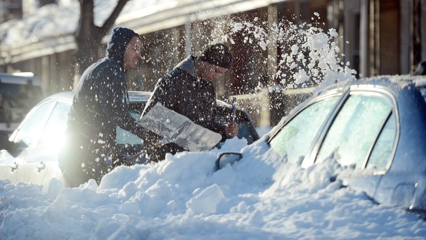 Luis Rodriguez and his brother shovel out a car on Tilghman Street in Allentown on Sunday afternoon, Jan. 24, 2016. Lehigh Valley residents began the big cleanup after the Blizzard of 2016 dumped a record 31.9 inches of snow on the region. (Emily Paine/The Morning Call)