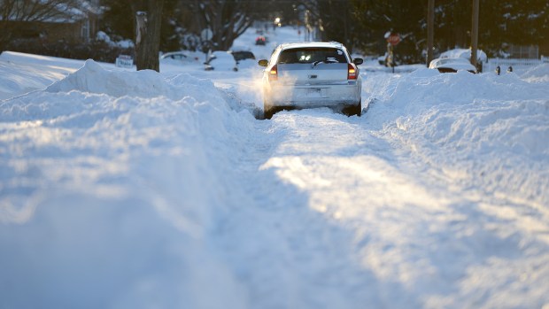 A vehicle struggles navigating down a snow-covered Pennsylvania Street in Allentown on Sunday afternoon, Jan. 24, 2016. Lehigh Valley residents began the big cleanup after the Blizzard of 2016 dumped a record 31.9 inches of snow on the region. (Emily Paine/The Morning Call)