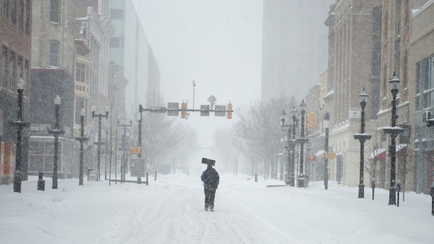 Armed with a shovel, a resident makes his way up Hamilton Street in Allentown on Saturday, Jan 23, 2016, during the Blizzard of 2016. (Chris Shipley/The Morning Call)
