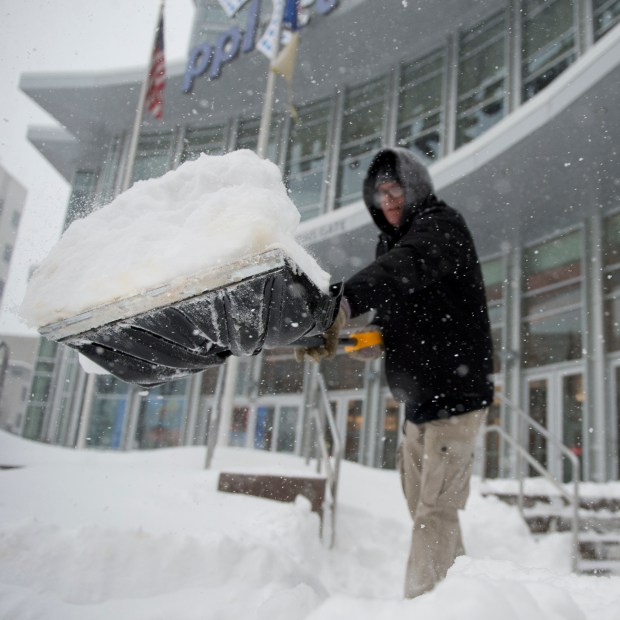 Workers remove snow Saturday, Jan. 23, 2016, in front of the PPL Center in downtown Allentown for patrons to attend that night's ArenaCross event during the Blizzard of 2016. (Chris Shipley/The Morning Call)