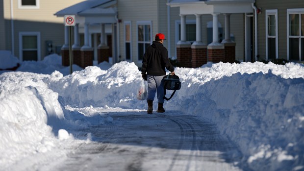 A man walks down East Turner Street in Allentown on Sunday afternoon, Jan. 24, 2016. Lehigh Valley residents began the big cleanup after the Blizzard of 2016 dumped a record 31.9 inches of snow on the region. (Emily Paine/The Morning Call)