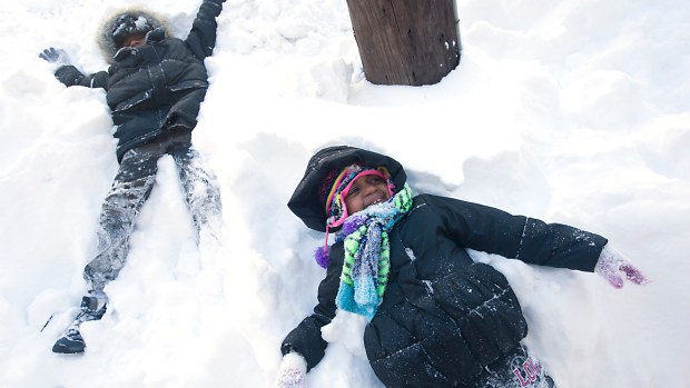 Khilynn Hartwell, 4 (foreground), and brother Khyni, 8, play in the snow along Turner Street in Allentown as Lehigh Valley residents dug out from the Blizzard of 2016 on Sunday, Jan. 24, 2016. (Harry Fisher/The Morning Call)
