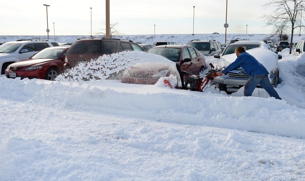 Nimaris Construction employee Richard Strawcutter of Albrightsville uses a snowblower to clear snow away from cars in the long term parking lot at Lehigh Valley International Airport. Crews at LVIA worked to remove snow from roadways and parking lots on Monday, Jan. 25, 2016, two days after 31.9 inches of snow fell on the Lehigh Valley during the Blizzard of 2016. (Emily Paine/The Morning Call)
