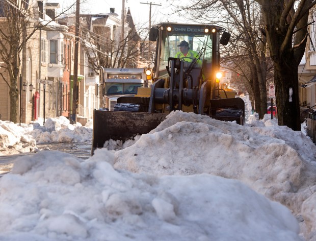 Allentown Streets Department employee Tim Flores operates a rubber tire loader to remove snow off of the 200 block of North 12th Street on Wednesday, Jan. 27, 2016, several days after the Blizzard of 2016 hit the Lehigh Valley. (Harry Fisher/The Morning Call)