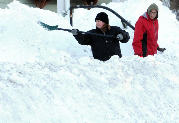 Melissa Cain throws a shovel full of snow on Sunday, Jan. 24, 2016, as she and her husband John Cain cleared snow from the sidewalk in front of their home on Main Street in Stockertown, the day after the Blizzard of 2016 hit the Lehigh Valley. (Ed Koskey Jr./Special to The Morning Call)