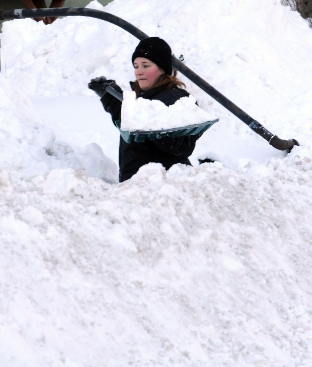 Melissa Cain lifts a shovel full of snow on Sunday, Jan. 24, 2016, as she and her husband John Cain cleared snow from the sidewalk in front of their home on Main Street in Stockertown the day after the Blizzard of 2016 hit the Lehigh Valley. (Ed Koskey Jr./Special to The Morning Call)