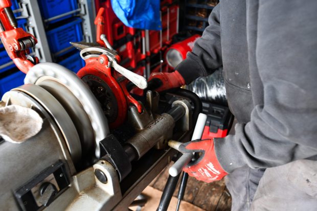 Jim Heery, technician for Smurl HVAC, operates a threading machine to thread black iron pipe for a gas line in the back of his truck to repair a steam boiler for a Dickson City resident on Thursday, January 22, 2026. (SEAN MCKEAG / STAFF PHOTOGRAPHER)