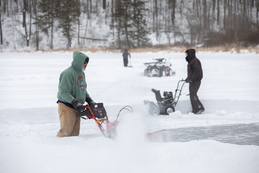 The "Ice Men" — including Chris Kane, Ken Lee and other volunteers — clear Lake Eston Wilson at Hillside Park in South Abington Twp. on Monday afternoon. They hoped to have the lake ready for ice skating on Tuesday.