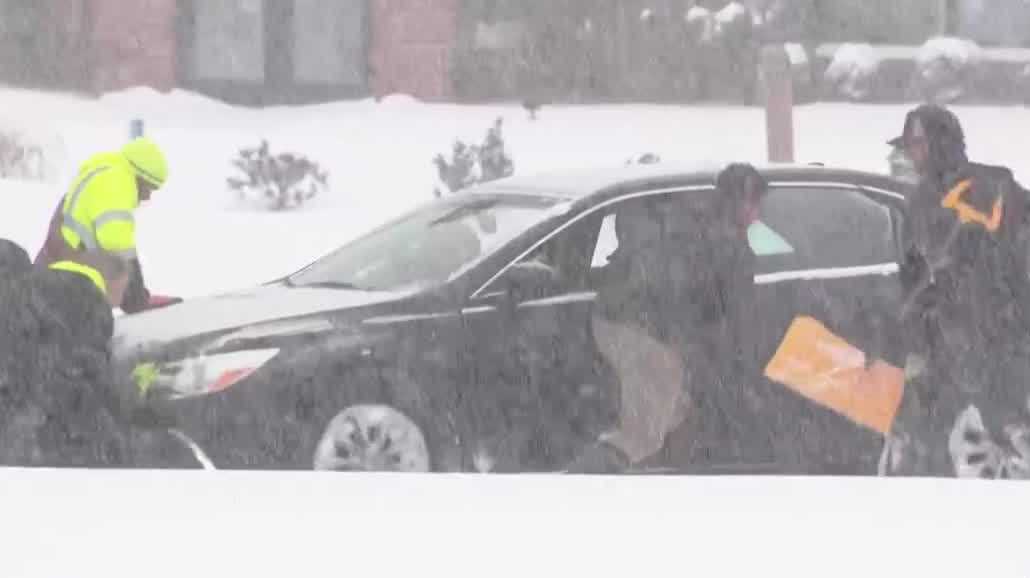 Bystanders jump in to free stuck car in Pittsburgh